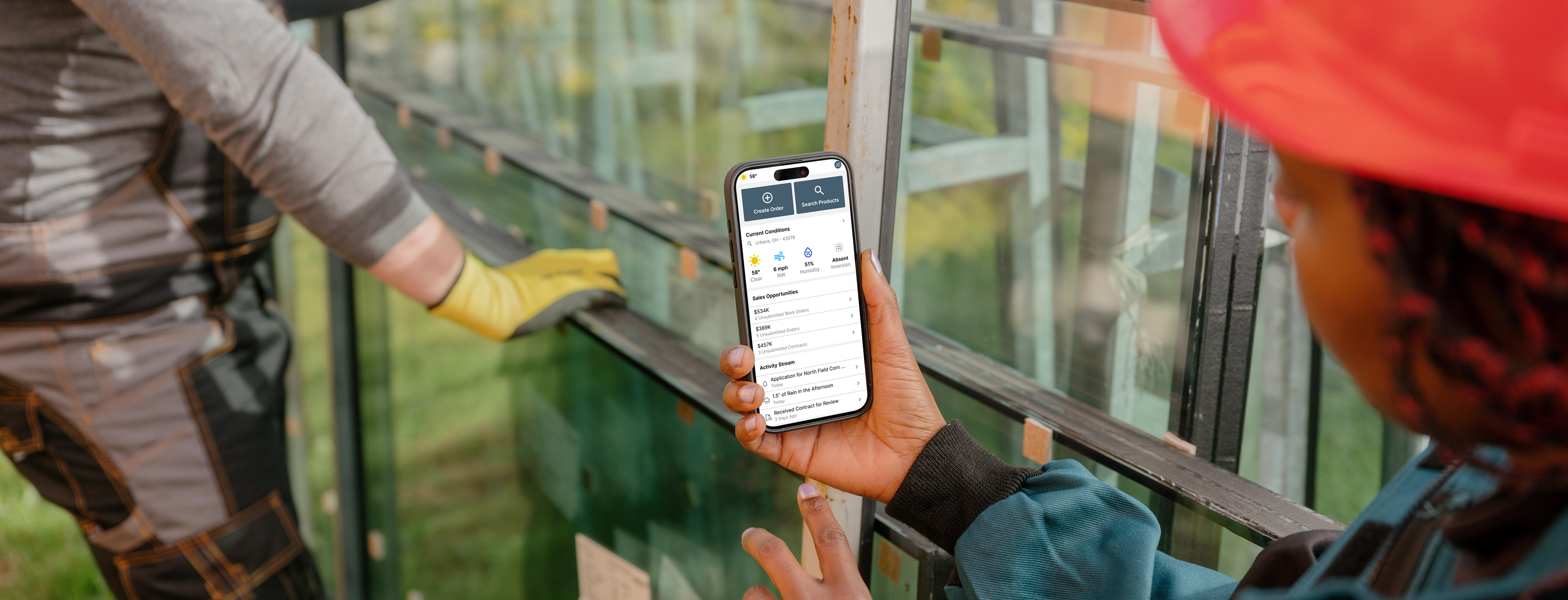 Field consultant using the Nutrien mobile app in a greenhouse